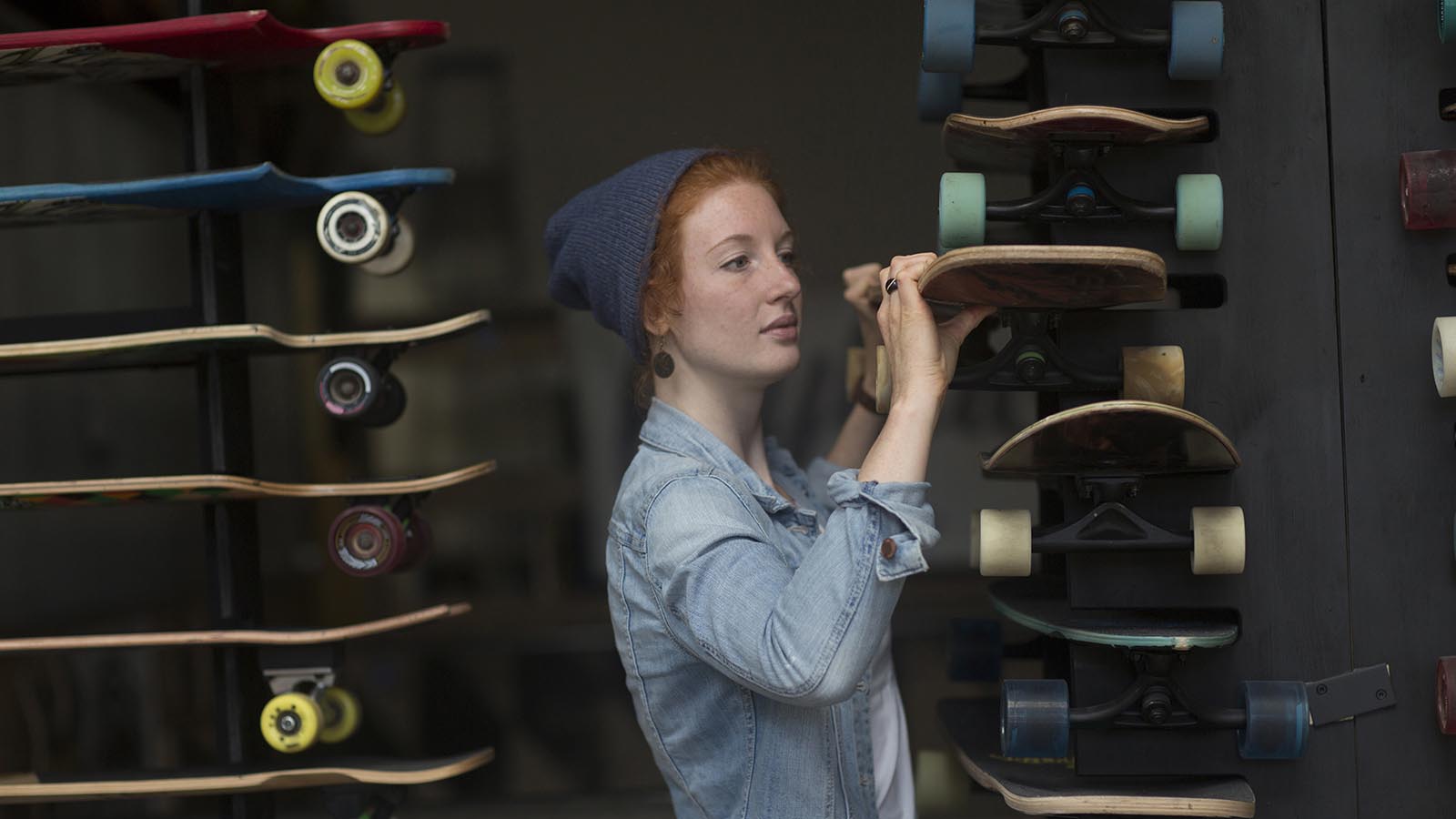Woman working in a skateboard shop
