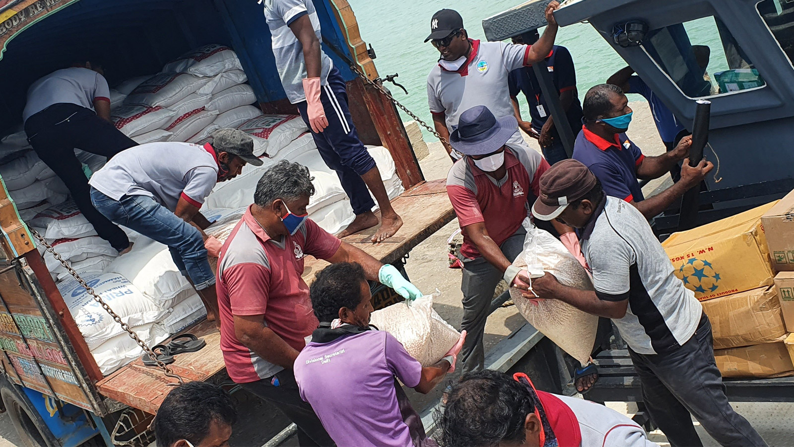 In Sri Lanka, a boat is being loaded with food parcels