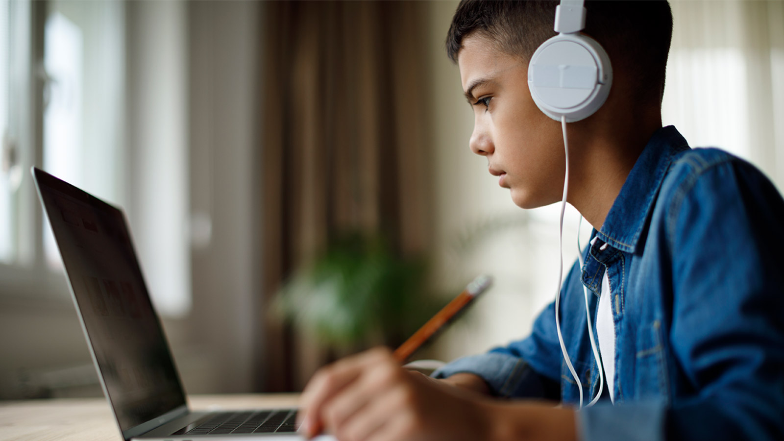 A boy doing schoolwork on his laptop