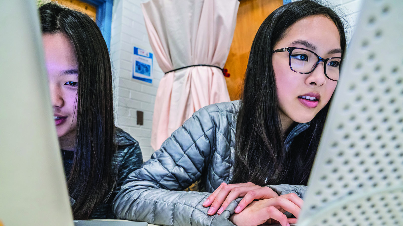 Two girls working on their laptops