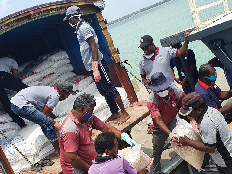In Sri Lanka, a boat is being loaded with food parcels 