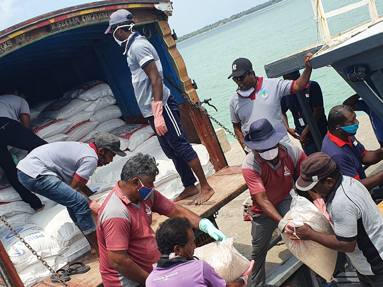 In Sri Lanka, a boat is being loaded with food parcels