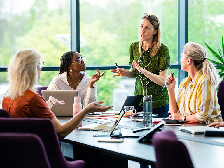 A group of people talking about a project