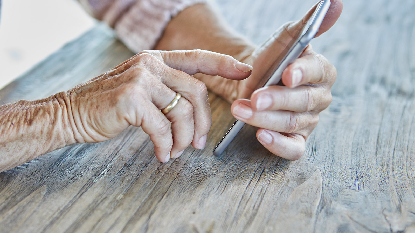 Woman’s hands using smartphone, close-up