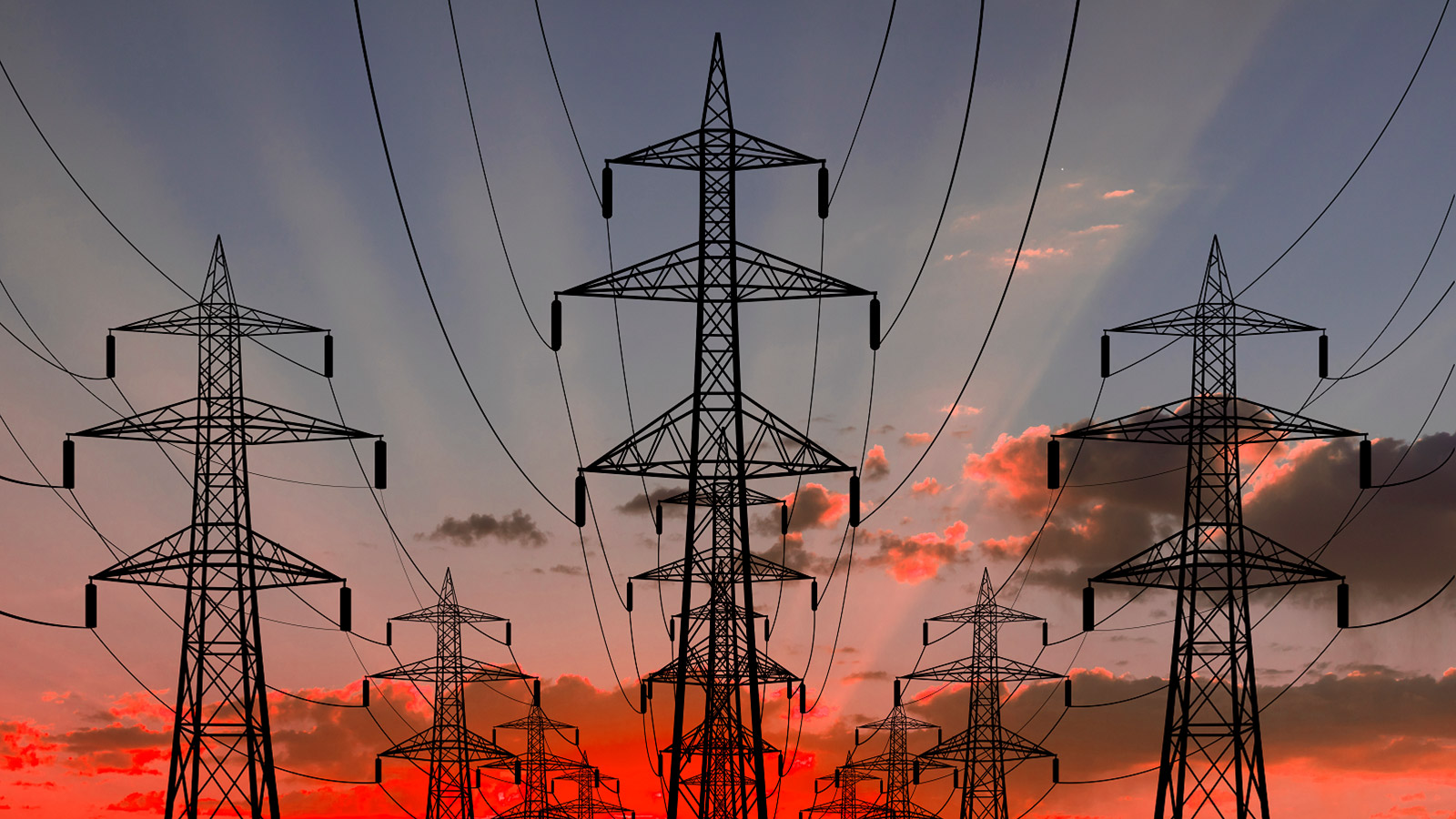 Electricity pylons against a sunset sky