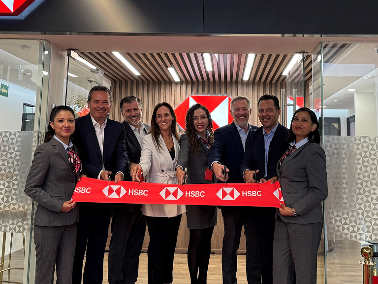 HSBC colleagues cutting a ribbon in the doorway of one of our wealth centres to signal its opening.