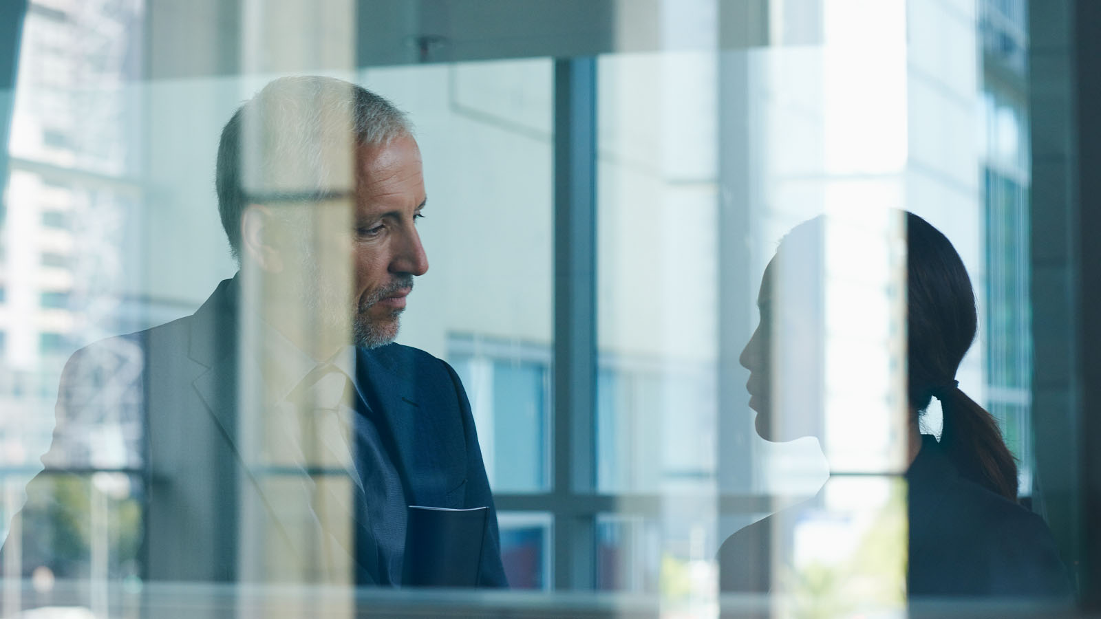 A businessman and businesswoman are in deep in discussion.
