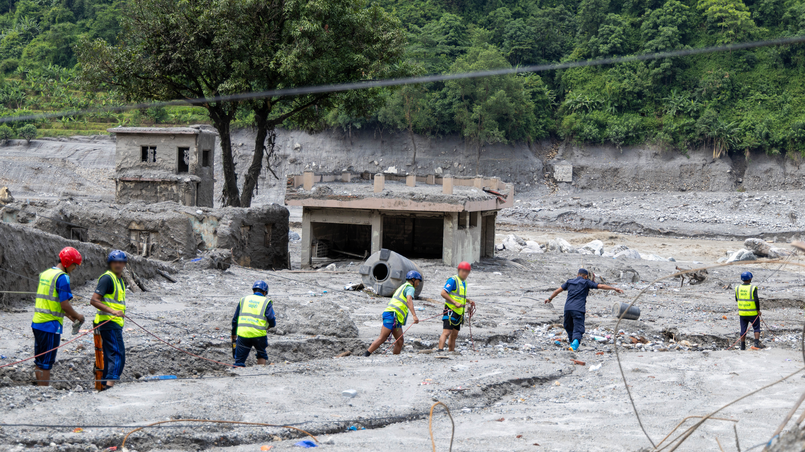 Rescue workers in an area devastated by flash flooding