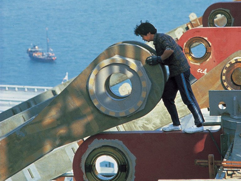 A construction photo showing a worker onsite positioning a large section