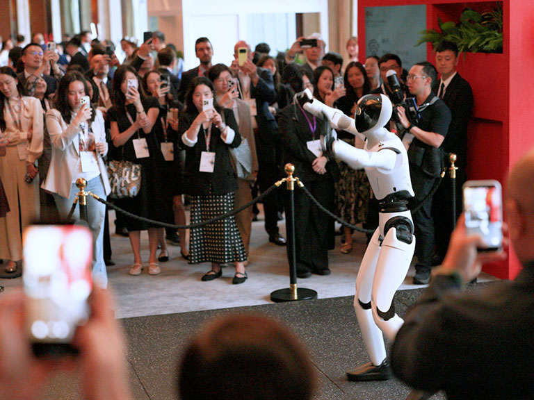 Image of a speaker on stage at the HSBC 13th Annual China Conference