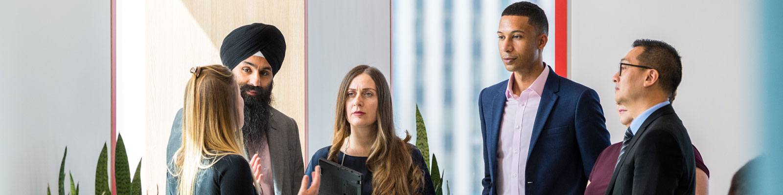 A group of six HSBC employees talk together