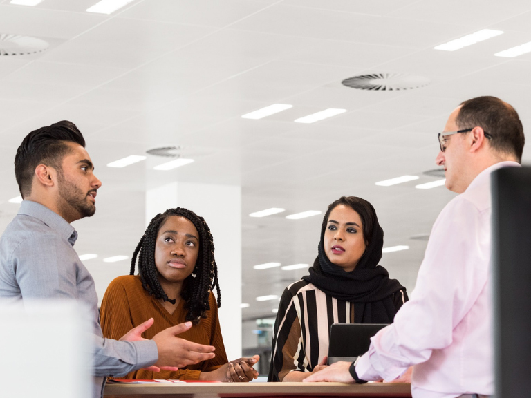 A group of six HSBC employees talk together